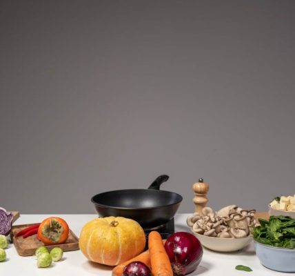 Studio composition of fresh vegetables and a frying pan, ideal for healthy cooking and recipe preparation.